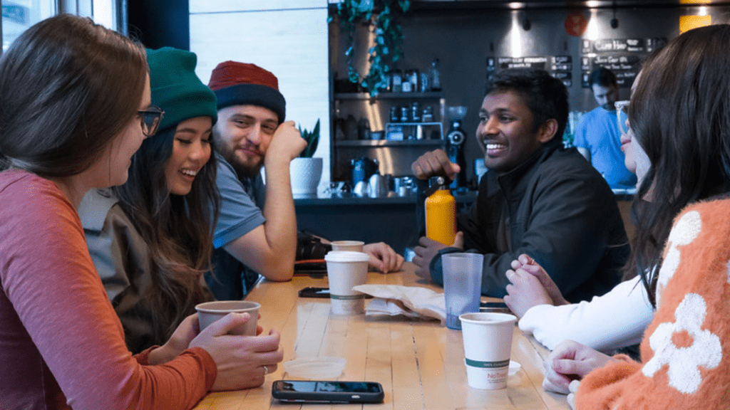 diverse group of friends chat in a coffee shop